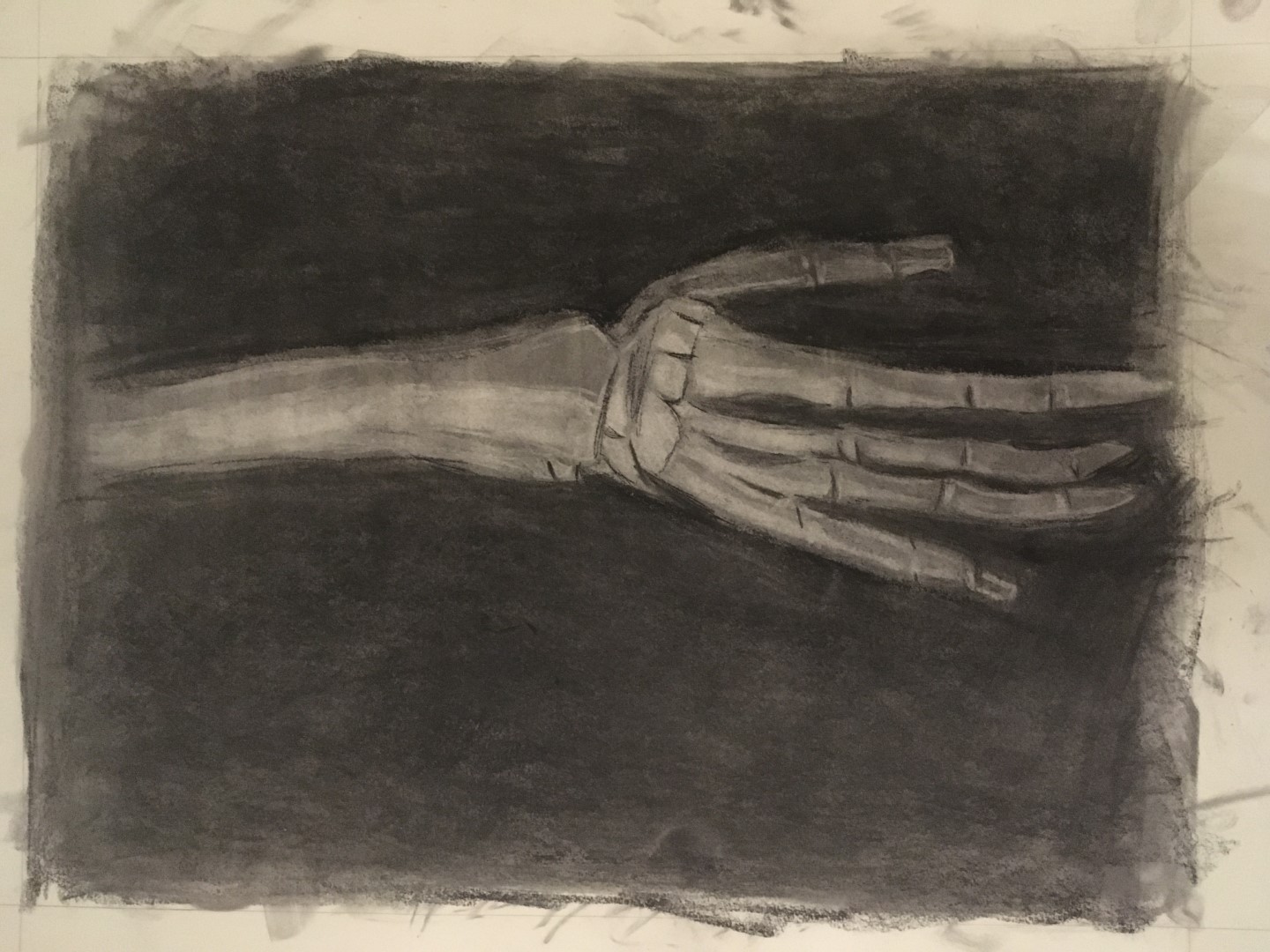 Black & white charcoal drawing of a skeletal hand